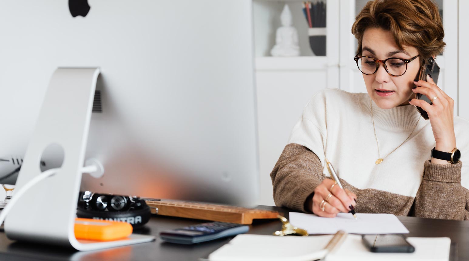 Claims administrator working in front of a computer.
