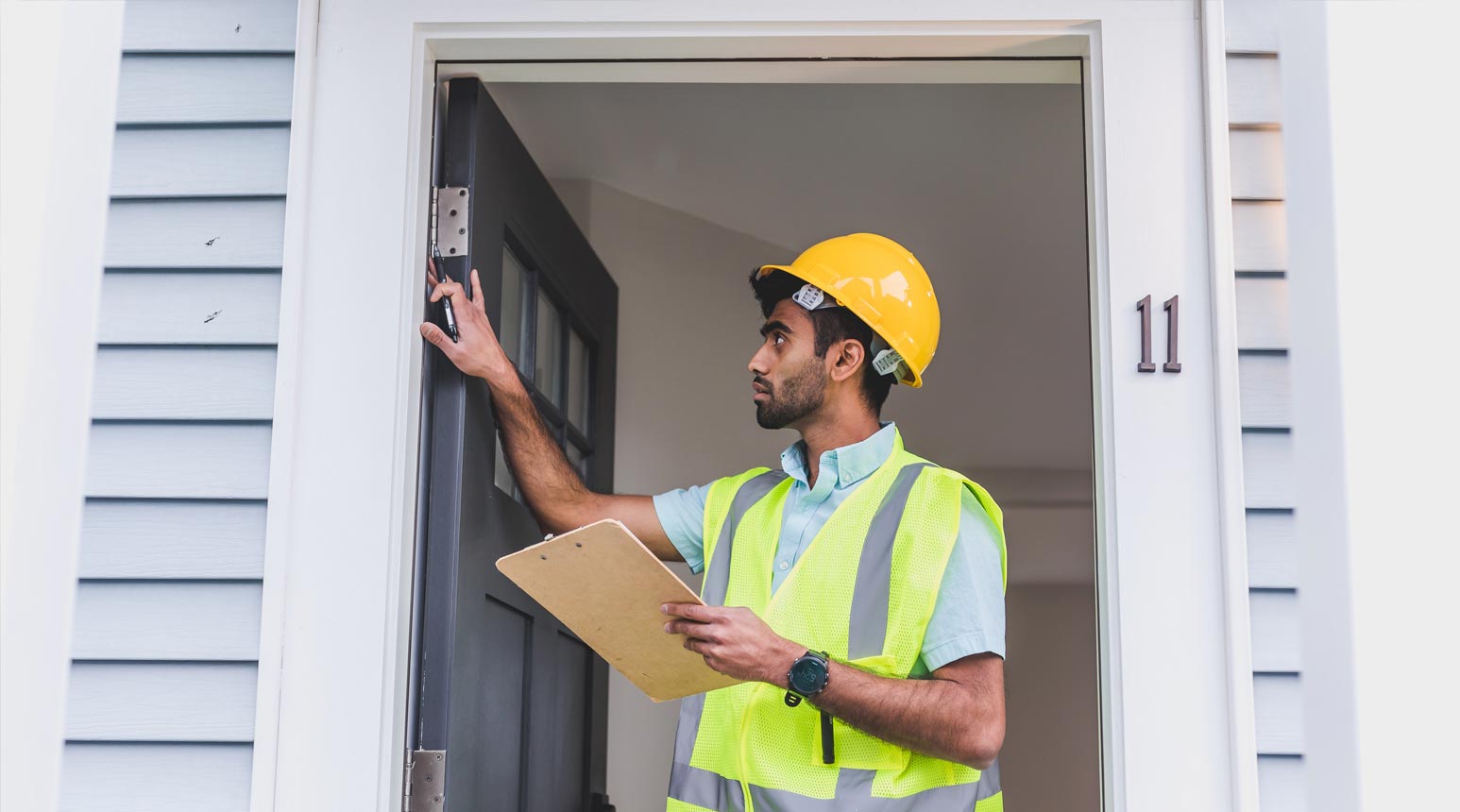 A domestic and residential adjuster in a hard hat.